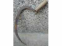 An old sickle with a seal, a knife, a blade, a wrought iron