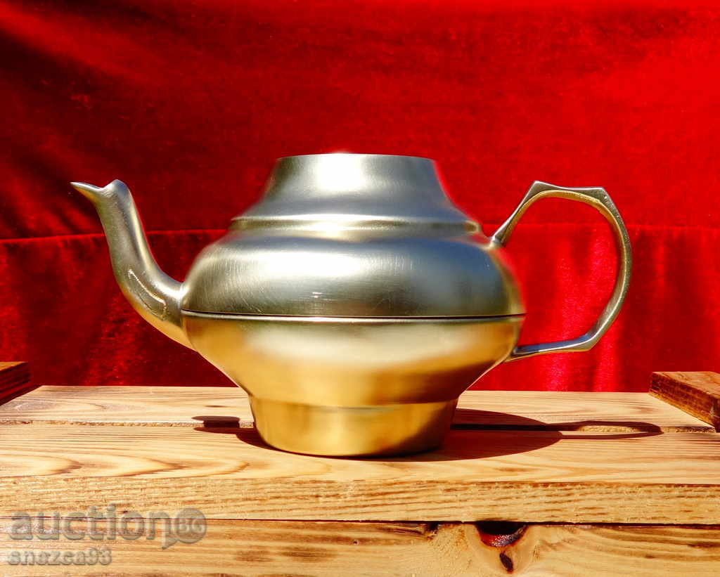 An old brass teapot.