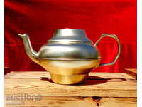 An old brass teapot.