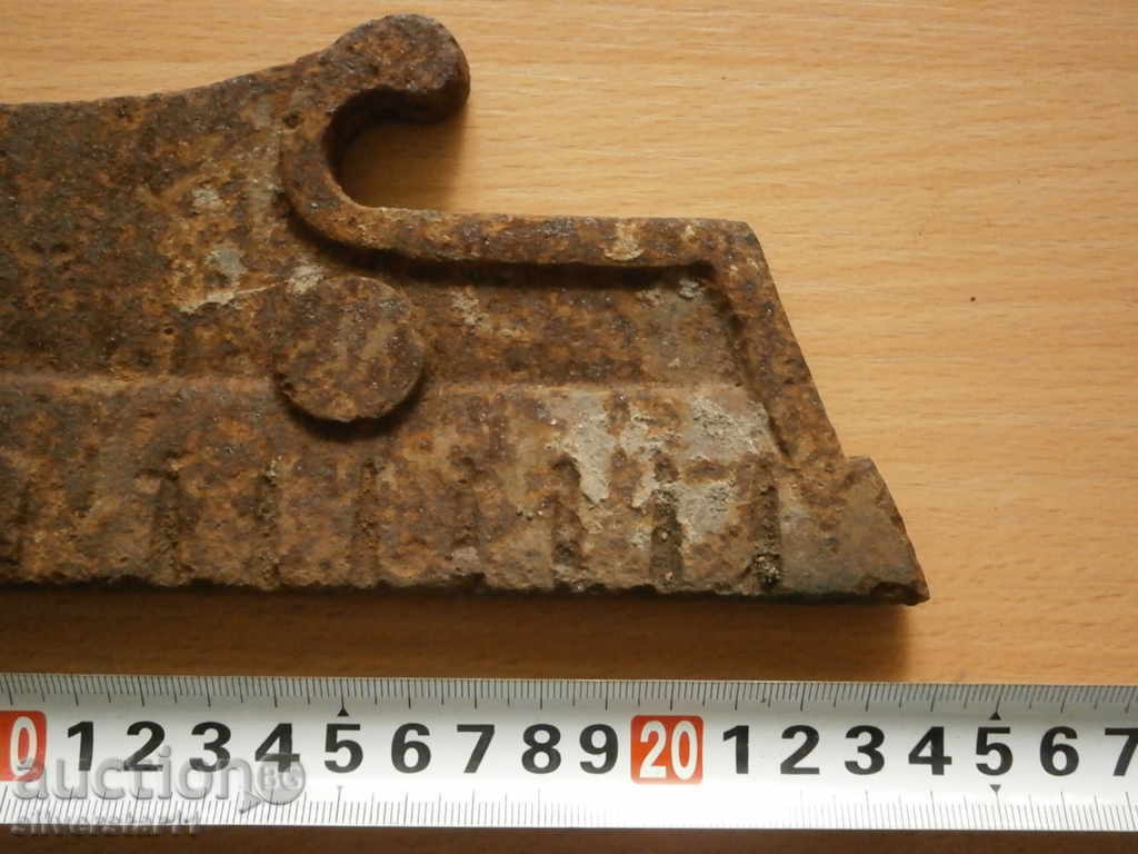 Auction cast iron part detail of an ancient fireplace Auction cast iron part detail of an ancient fireplace