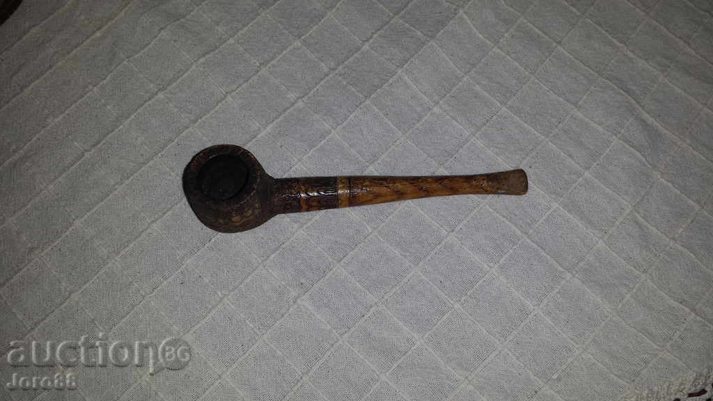 Old wooden pyrographed pipe
