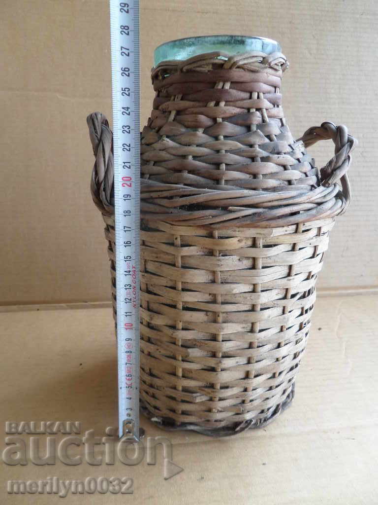 Delivery of Old rattan jar with a whip wicker bottle Delivery of Old rattan jar with a whip wicker bottle