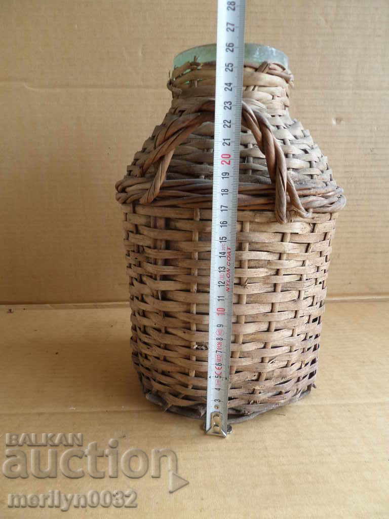 Delivery of Old rattan jar with a whip wicker bottle Delivery of Old rattan jar with a whip wicker bottle