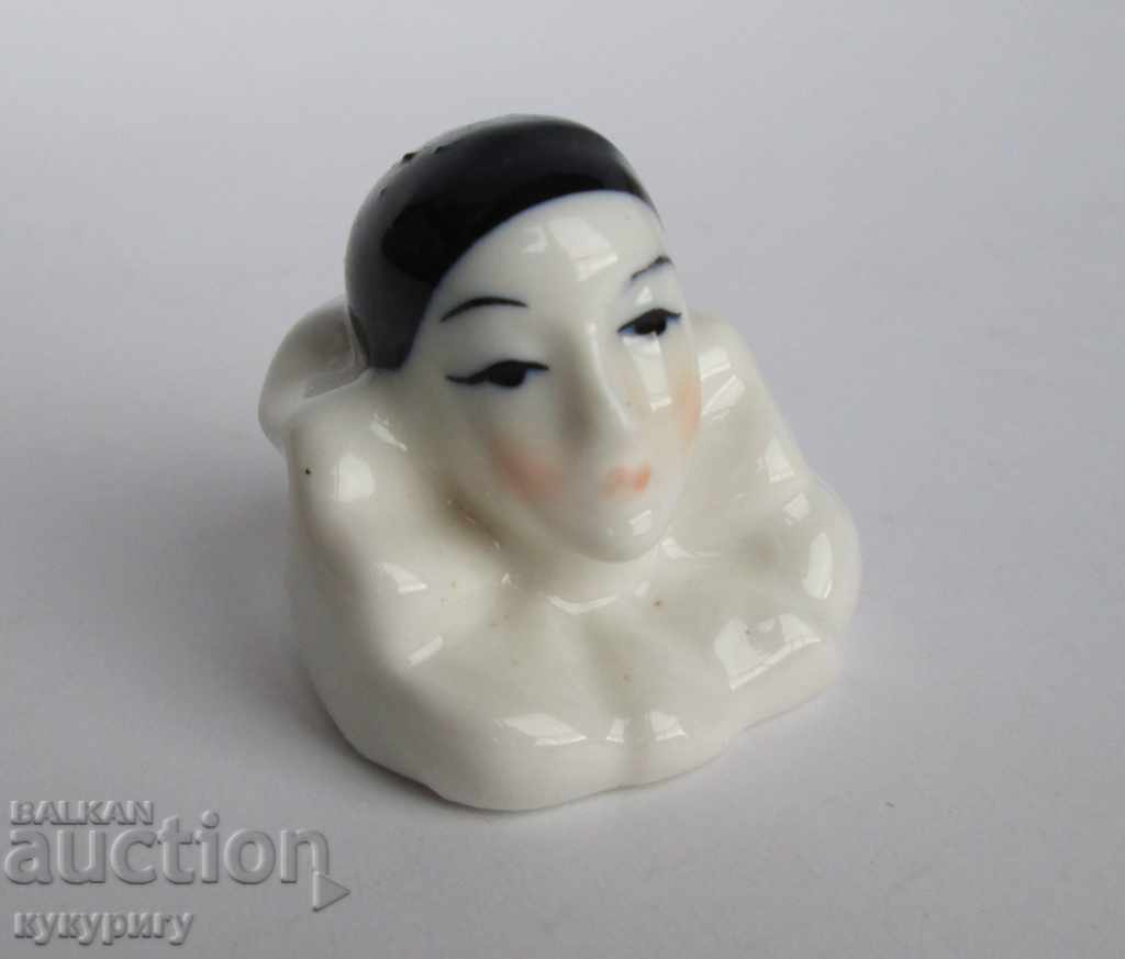 An old small porcelain statuette figurine Arlequin