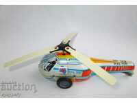 Old tin children's toy mechanical metal helicopter