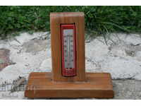 An old mercury thermometer with a stand