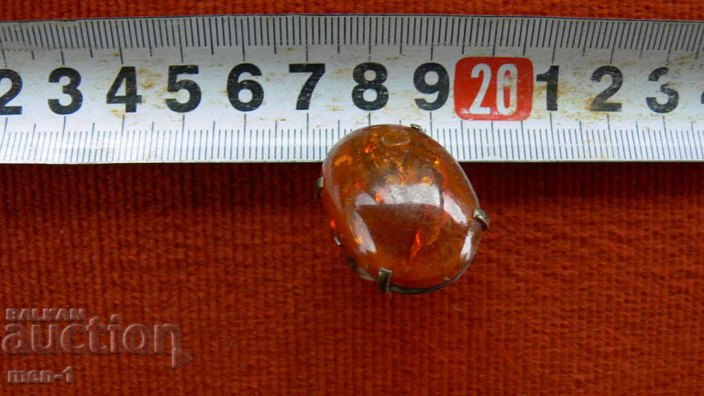 Old bronze ring with amber