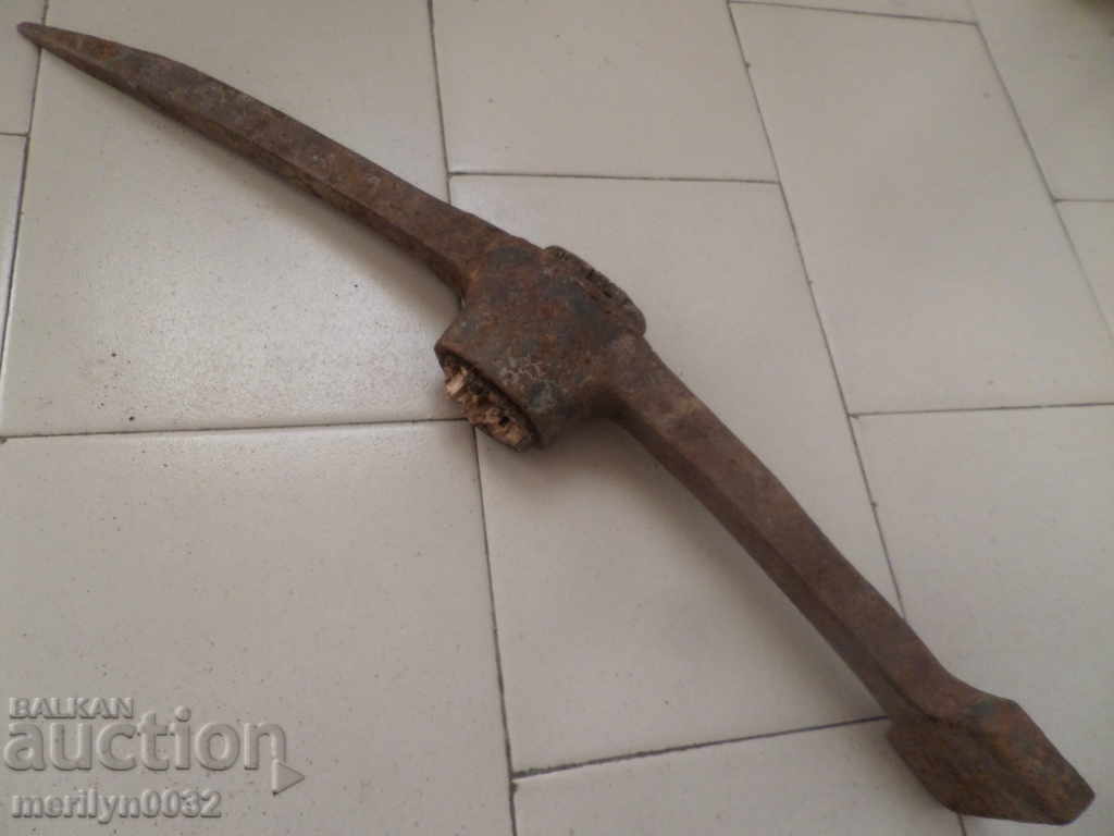 Delivery of Old hand-forged pickaxe tool wrought iron