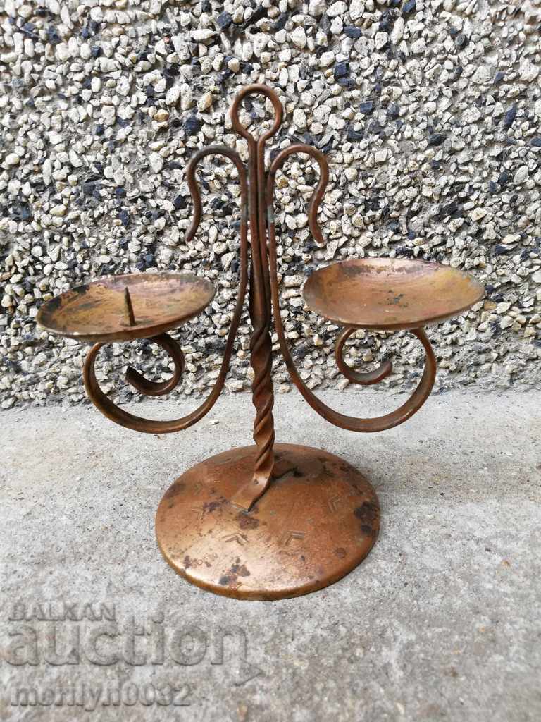 Old wrought copper candlestick from the social period, candle