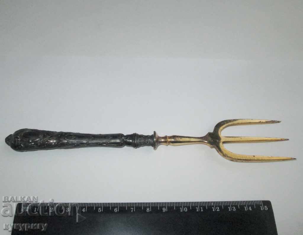 Delivery of A great old fork for serving a golden silver handle Delivery of A great old fork for serving a golden silver handle