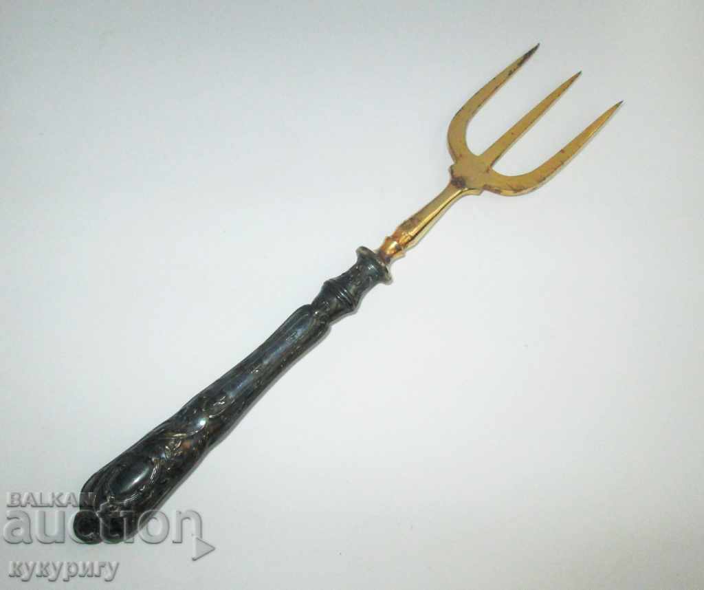 A great old fork for serving a golden silver handle