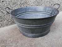 An old galvanized basin, a trough, a household pot