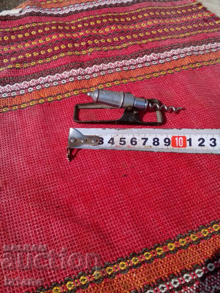 Auction  An old bottle opener