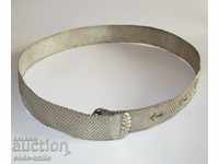 A beautiful old antique silver braided belt clutched