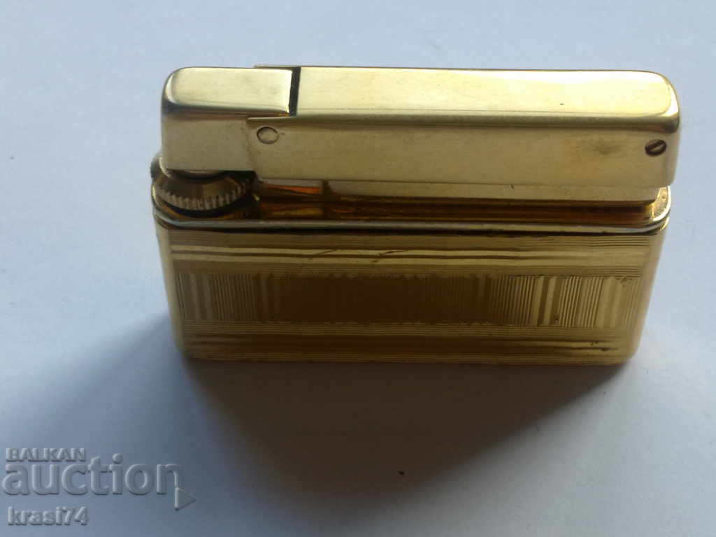 Delivery of An old, gilded lighter Delivery of An old, gilded lighter