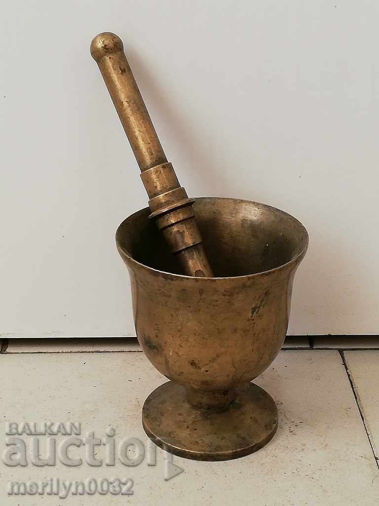 Old bronze mortar with hammer, mortar