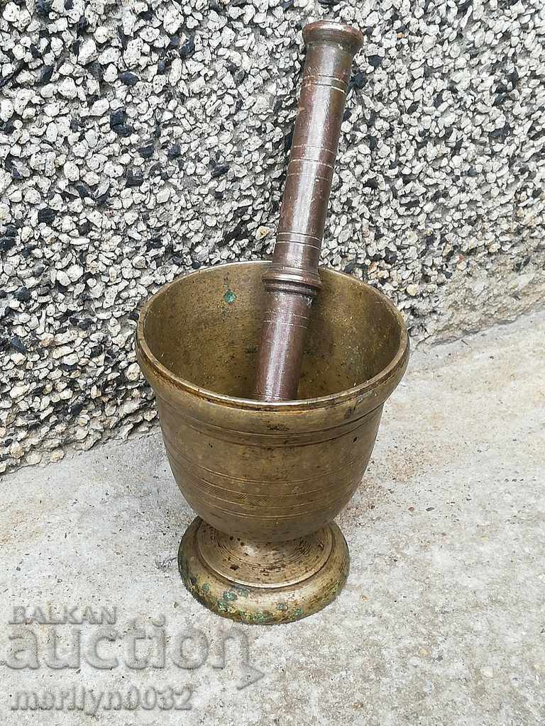 Old bronze mortar with hammer, mortar