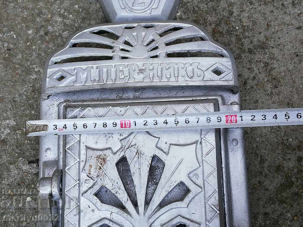 Auction  Emblem and doors from an old Jamal stove, figured cast iron