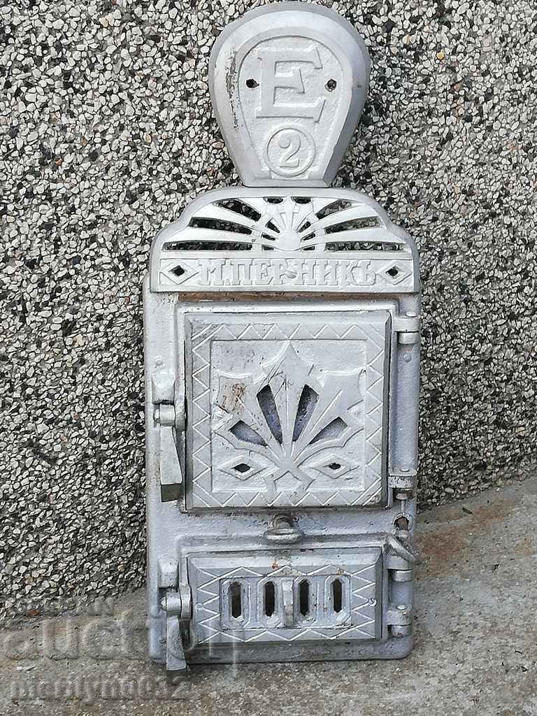 Emblem and doors of an old stove jamal shaped cast iron
