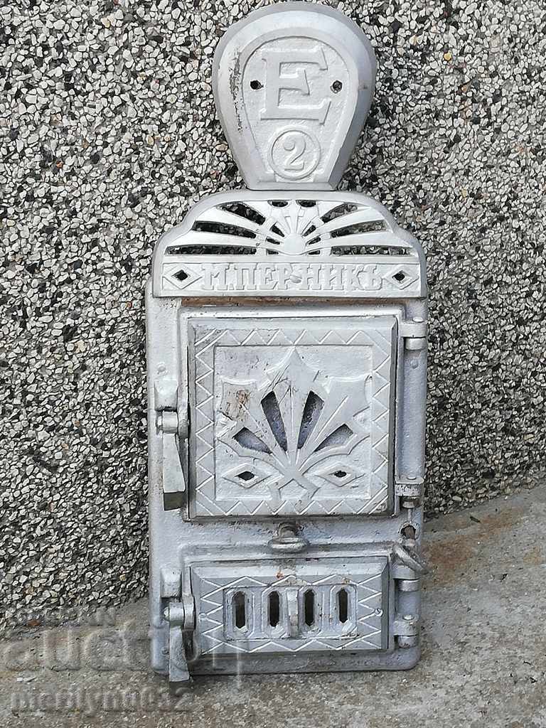Emblem and doors from an old Jamal stove, figured cast iron