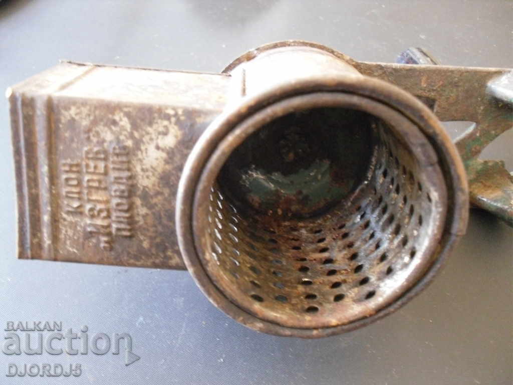 Auction  An old grinder marked