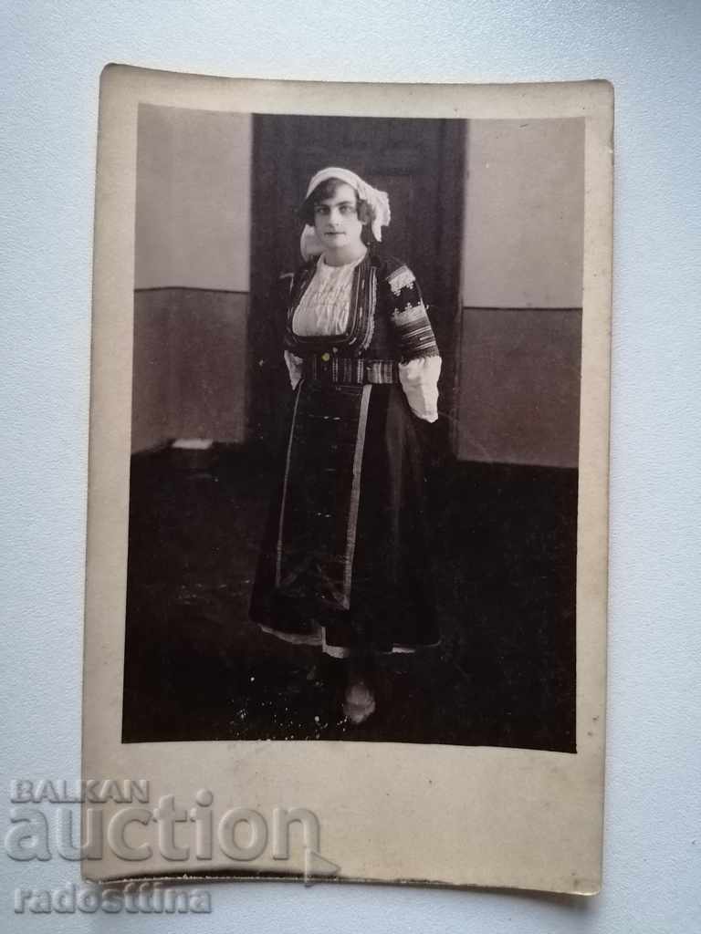 Old photo of a folk costume girl