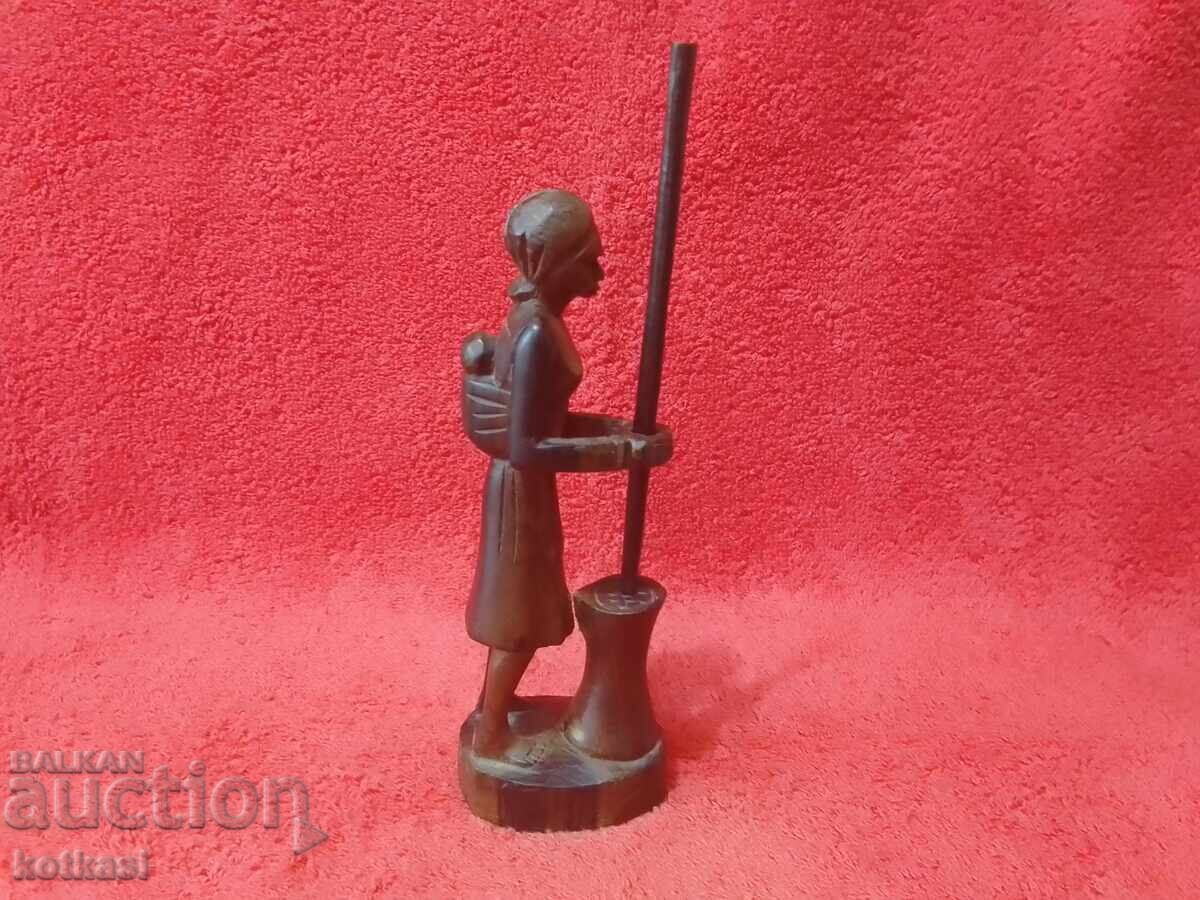 Old wood carving figure of a woman mother with child working Old wood carving figure of a woman mother with child working