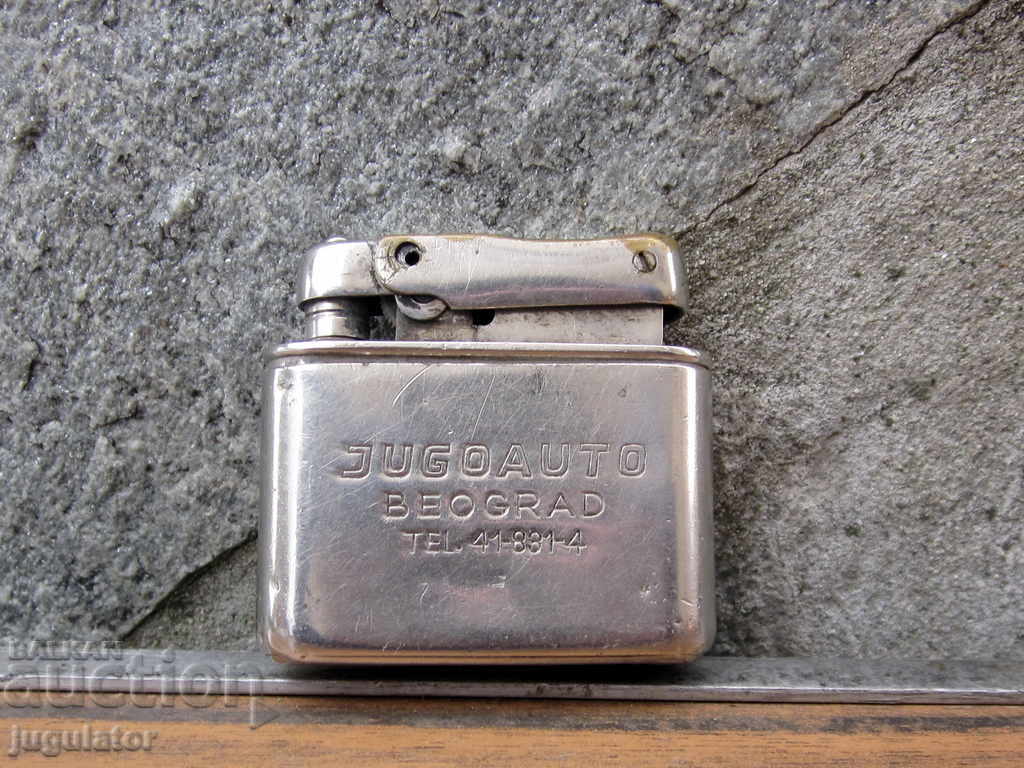 an old gasoline lighter for cars stands JUGOAUTO