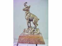 Old bronze statuette with a goat
