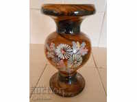 An old wooden vase with painted flowers