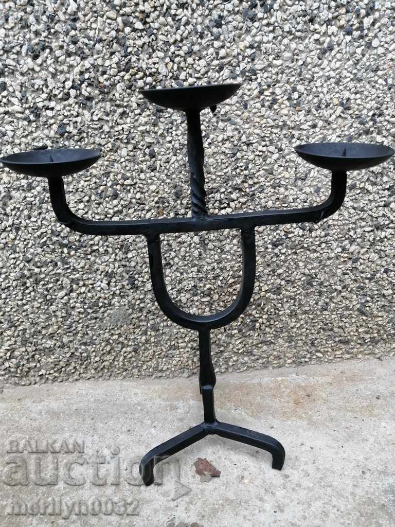 Old forged candlestick, candle, candelabra