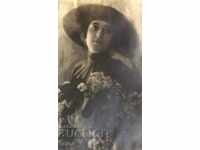 An old photo of a lady with flowers