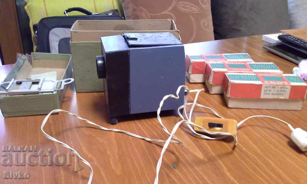 Projector with three boxes of slides