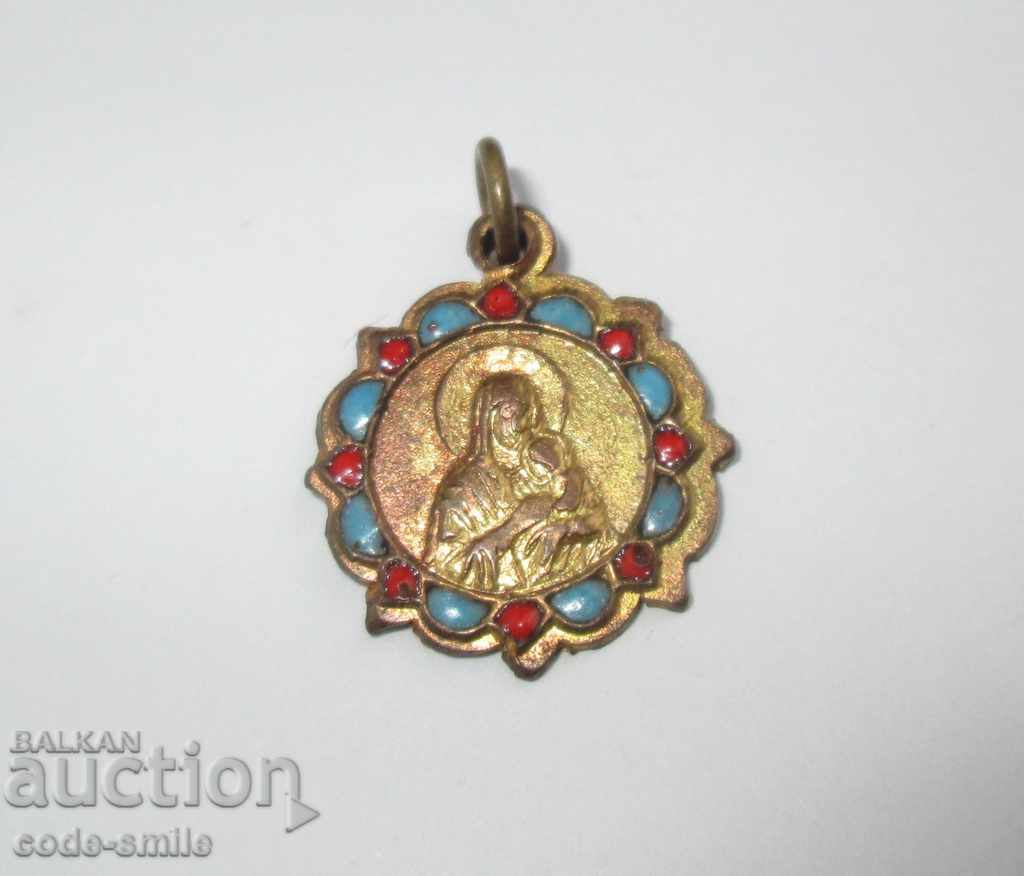 Old gilded religious medallion with enamel icon of the Mother of God