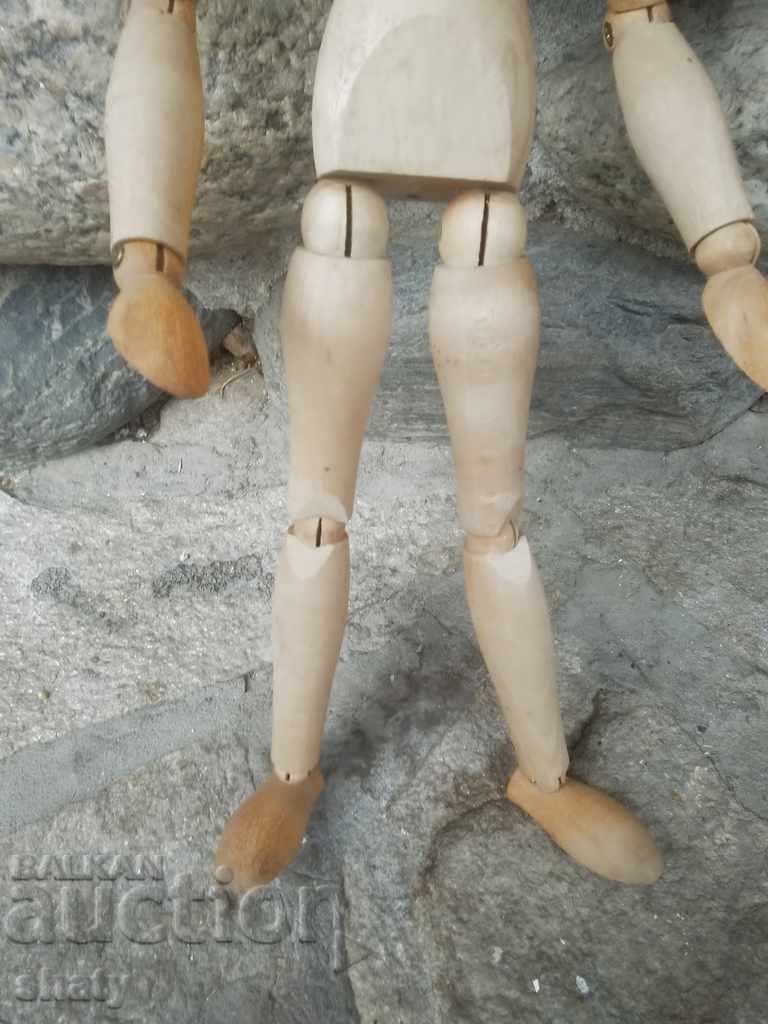 Auction  A wooden man with hinges.