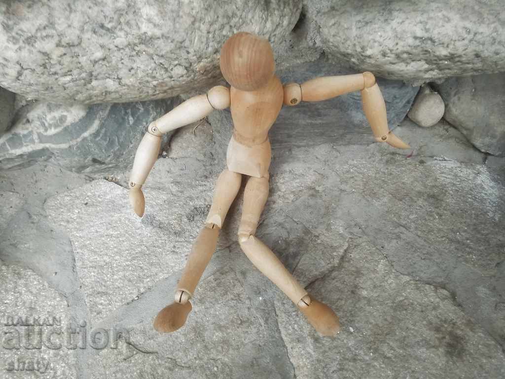 A wooden man with hinges. - 5
