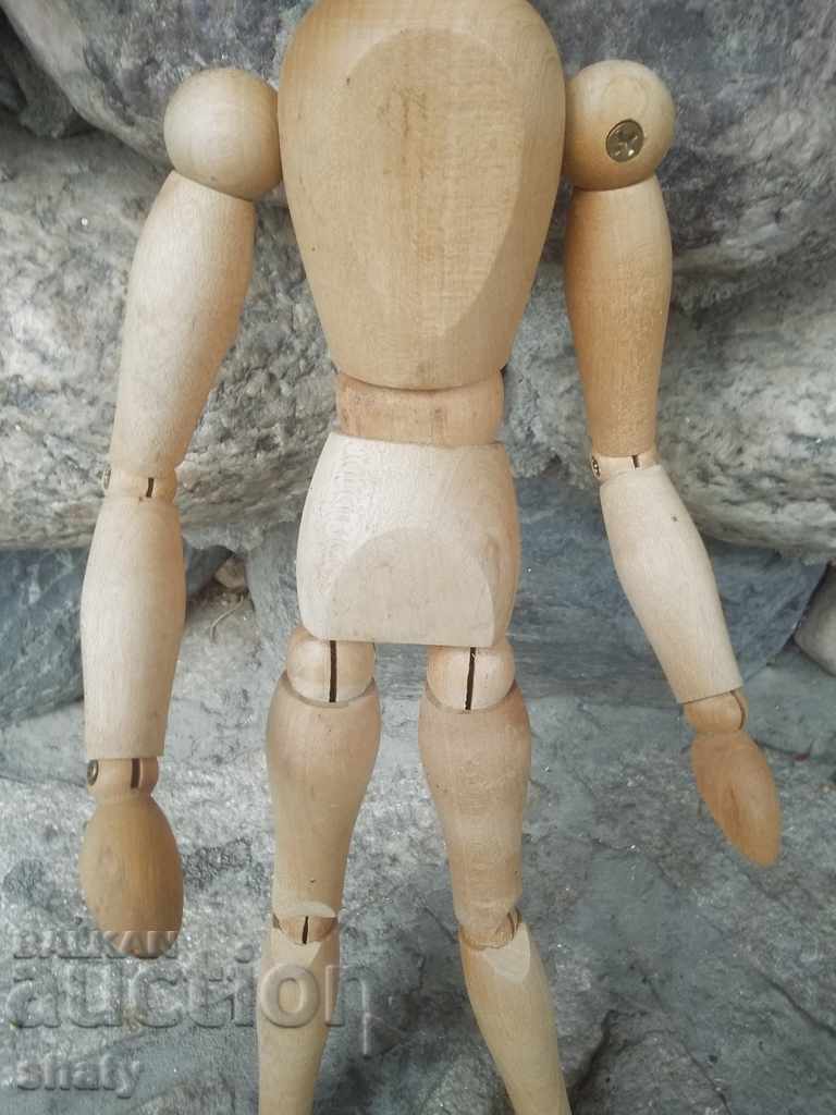 A wooden man with hinges. - 6