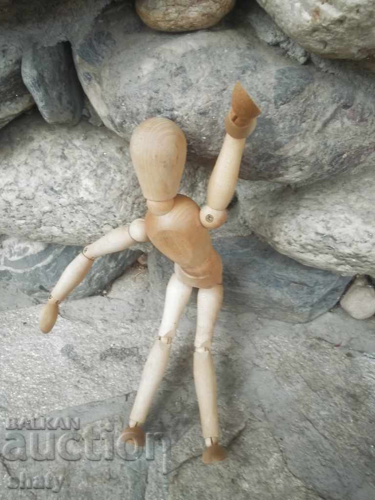 A wooden man with hinges. - 7