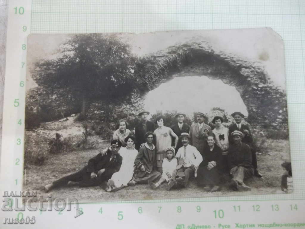 A photo of an old group of people on a picnic