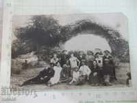 A photo of an old group of people on a picnic