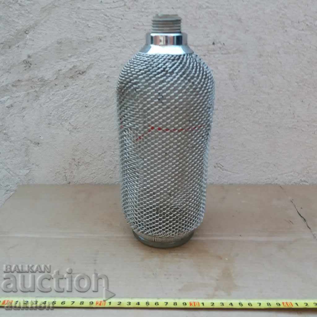 OLD SODA SIPHON, GLASS BOTTLE SOLIDLY COATED IN NET