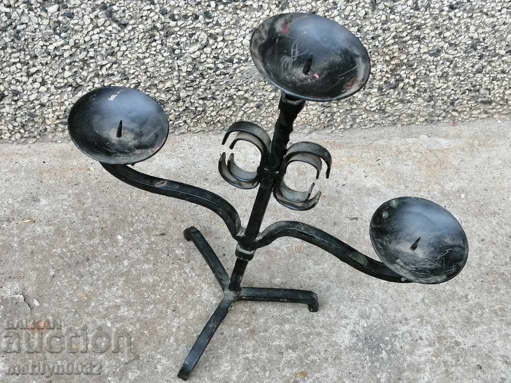 An old candle made of wrought iron lamp