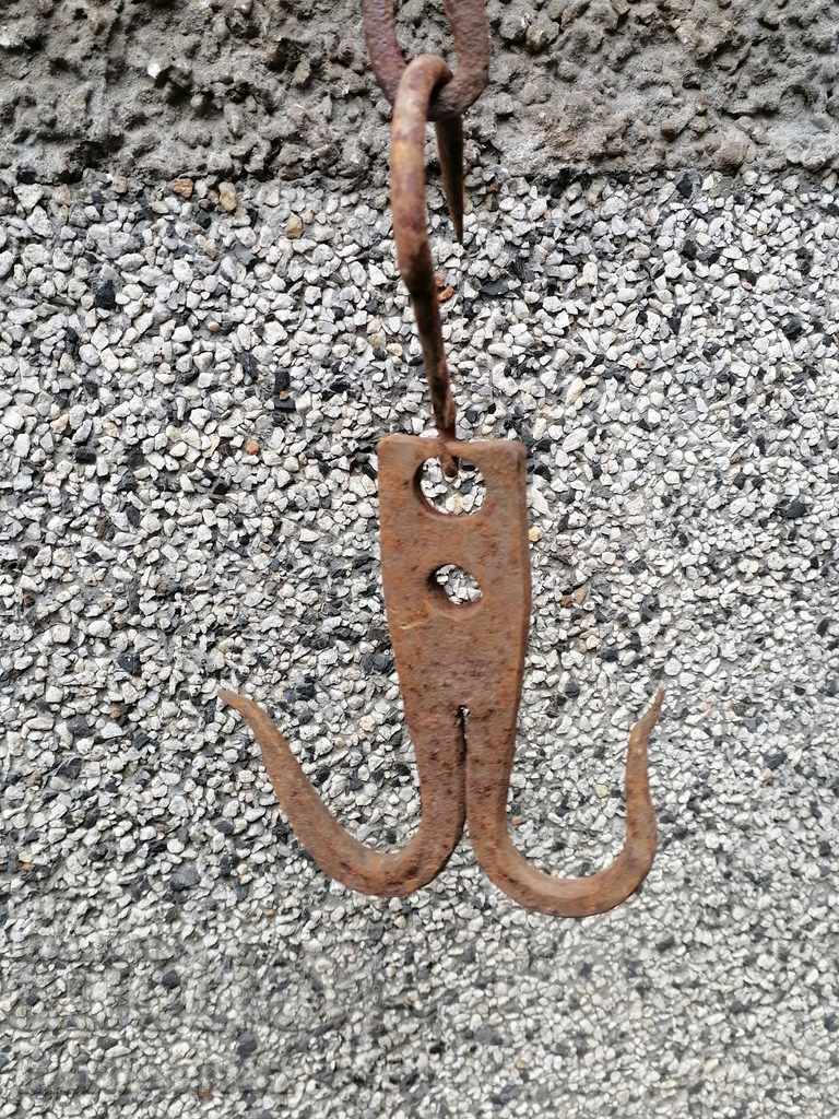 An old forged hook for scraping, a cock, anchor
