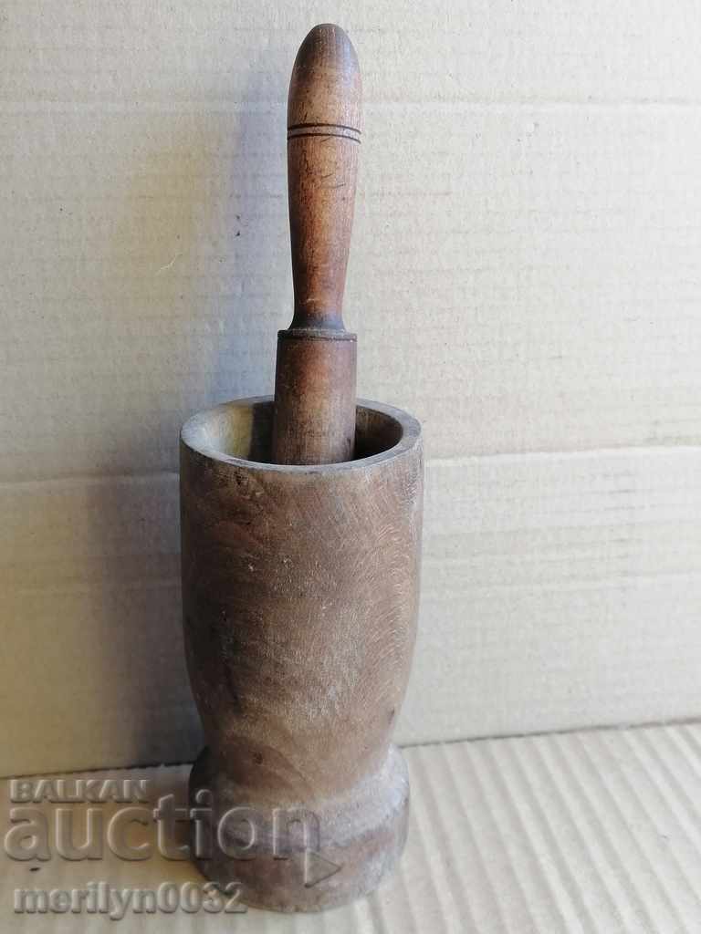 An old wooden mortar with hammer, mortar, chute, wooden