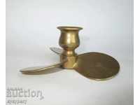 Old bronze small candlestick in the shape of a ship's propeller