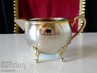 Silver-plated jug, brass saucer.