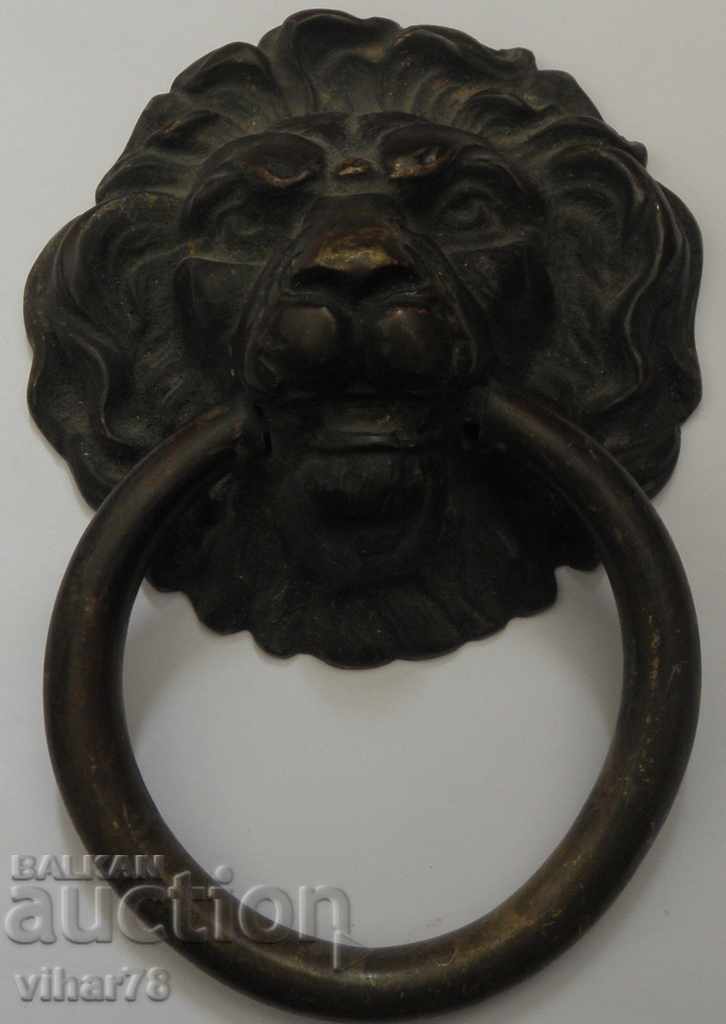 Old massive bronze door knocker "LION'S HEAD".