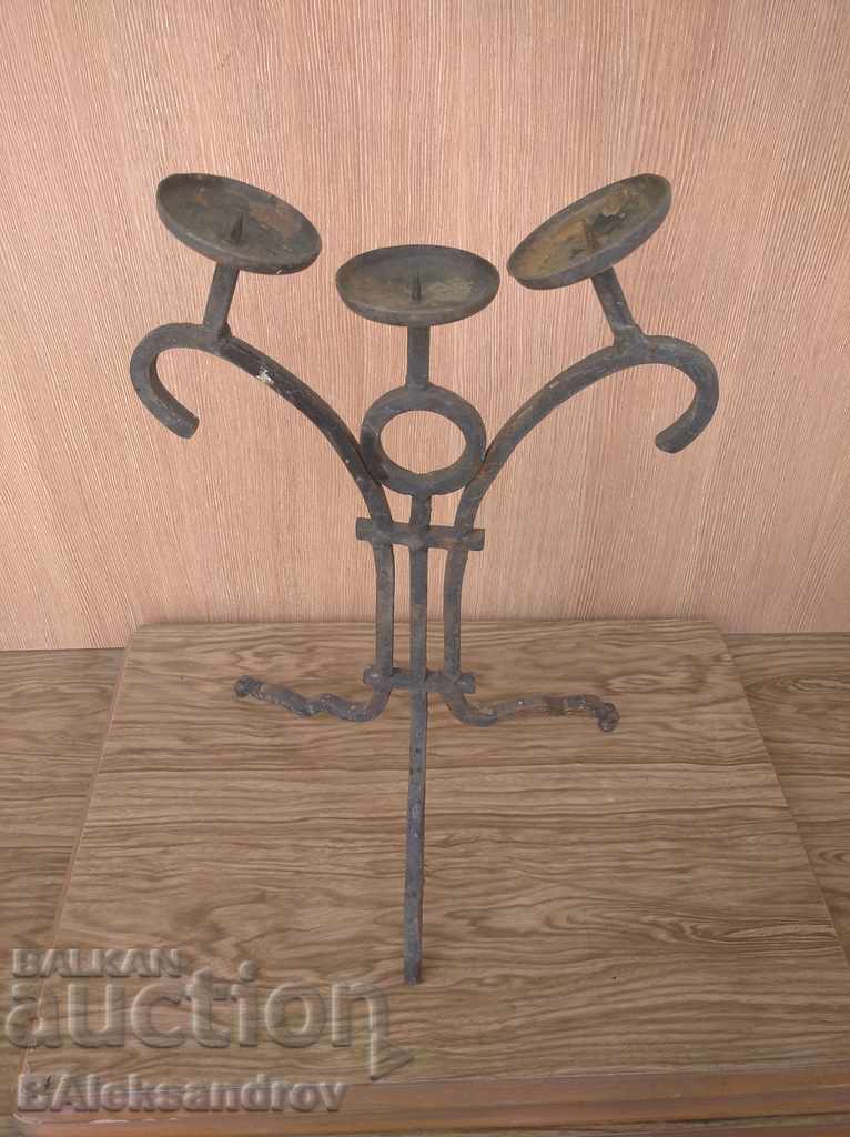 Auction An old forged candlestick Auction An old forged candlestick