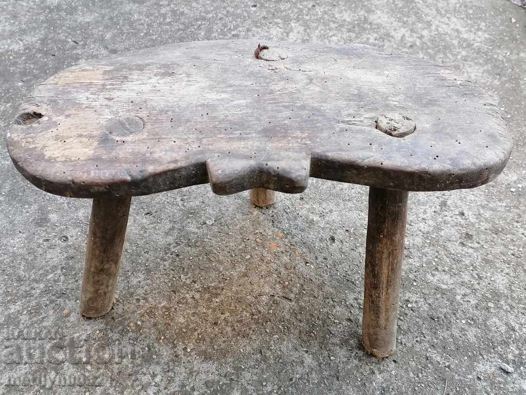 Old three-legged stool, chair, wooden, primitive