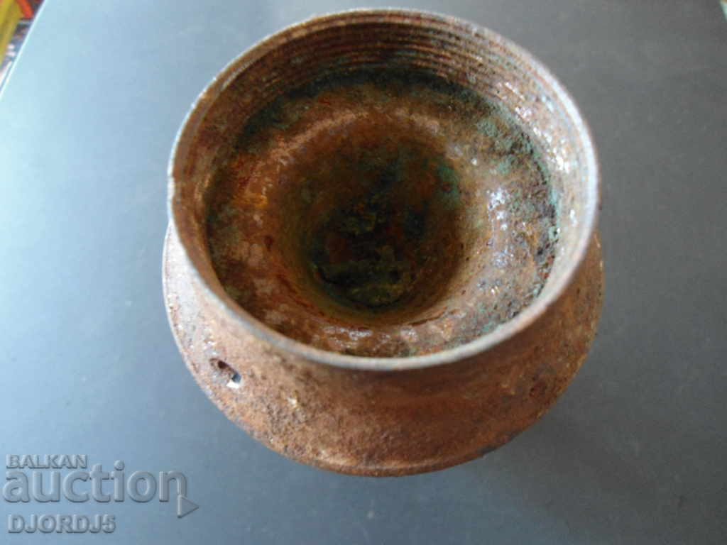 Auction An old metal candleholder Auction An old metal candleholder